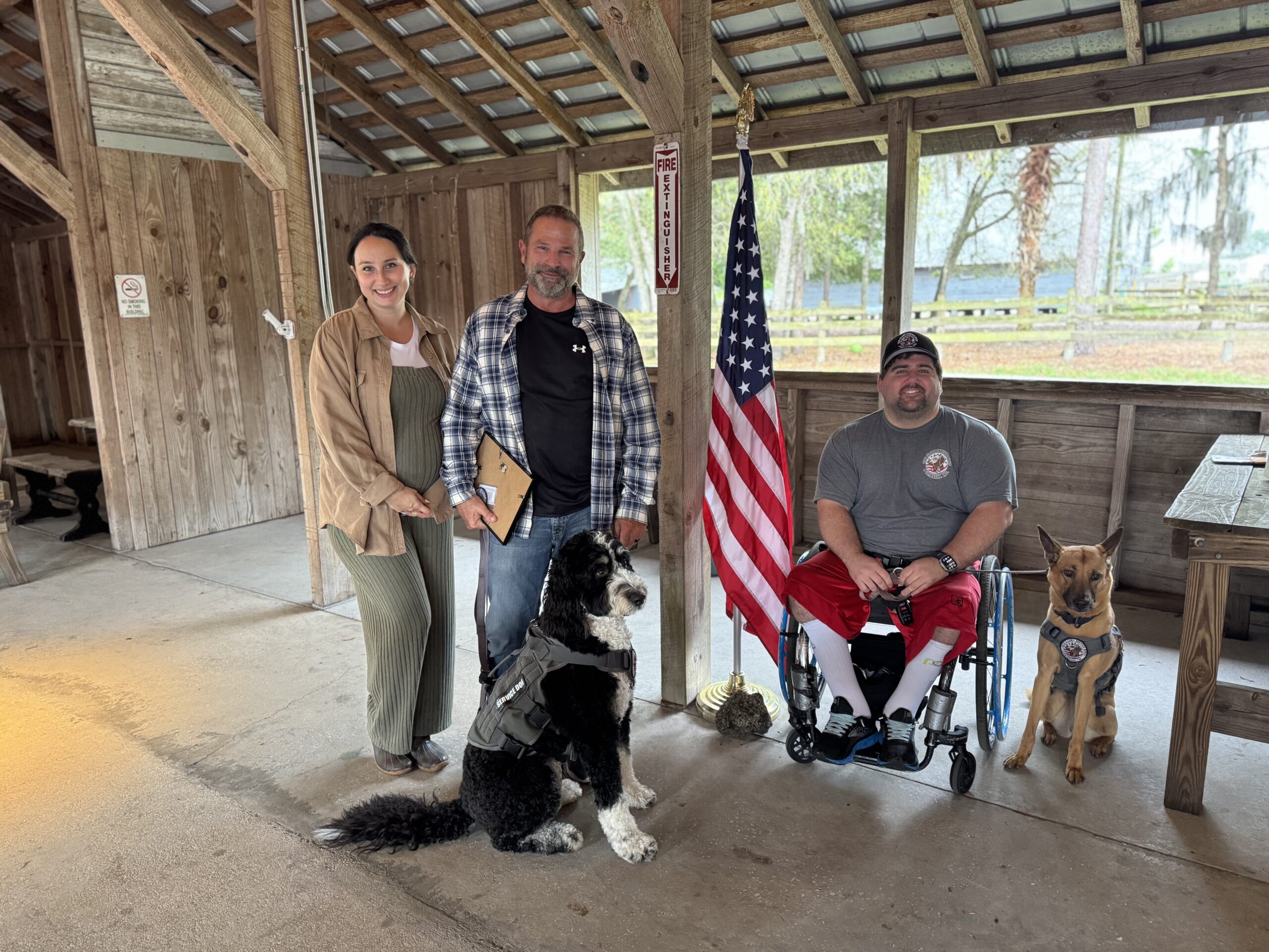 Old Glory members and service dogs gathered with an American flag